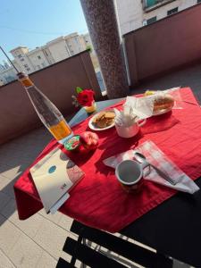a red table with food and a bottle on top of it at B&B Vescovo Rosso in Cosenza +28 photos