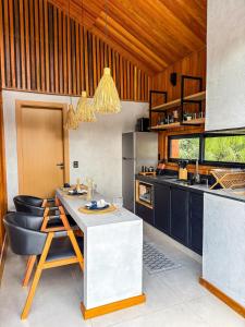 a kitchen with a counter and a table and chairs at Cabana Komodo Bonito in Bonito