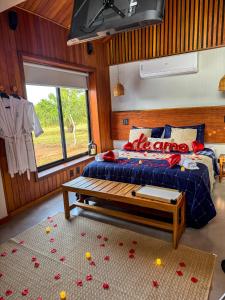 a bedroom with a bed with red roses on the floor at Cabana Komodo Bonito in Bonito +43 photos