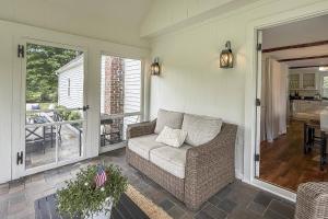 a living room with a couch and a balcony at Bluestone Cottage in Goshen