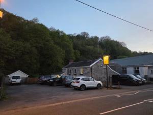 a parking lot with cars parked in front of a house at The Old Tredegar in Gwys Station