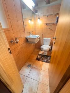 a bathroom with a toilet and a sink at Kyma in Gerolimenas +30 photos