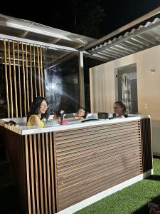 a group of people taking a bath in a tub at Morada Silvestre in La Peña