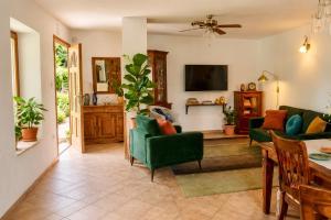 a living room with green chairs and a table at Villa Nona Tamara with Astonishing Sea & Mountains View in Bribir