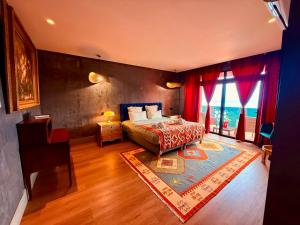 a bedroom with a bed and a large window at Al Dazk in Ribeira Brava +39 photos