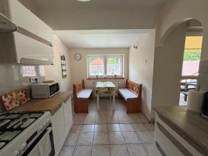 a kitchen with two chairs and a table in it at Agroturystyka ''Dom Pod Karpiem'' in Zagórze Śląskie