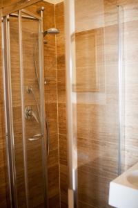 a shower with a glass door in a bathroom at Lisca Bianca Tropea in Tropea