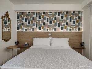 a bedroom with a bed and a wall with a mirror at Turistica Via Po 7 in Legnago +44 photos