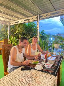 a group of three people sitting at a table at WLA Homestay in Labuan Bajo