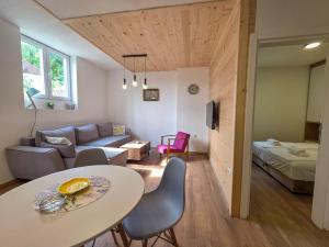a living room with a table and a couch at na obali drine in Perućac +108 photos