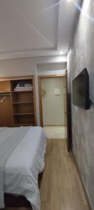 a bedroom with a bed and a flat screen tv at infinity by Ghita in Rabat