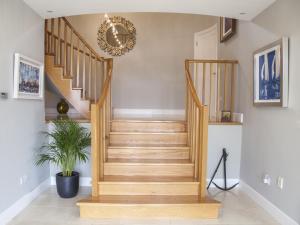 a wooden staircase in a home with a potted plant at Seafort Luxury Hideaway in Bantry