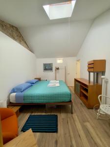 a bedroom with a bed and a chair in it at Casa da Granja in Sobral de Monte Agraço +26 photos