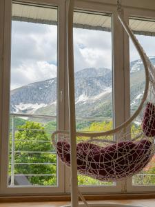 a chair in front of a window with a view at Gorštak in Žabljak