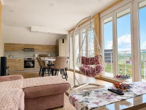 a living room with a hammock hanging from the ceiling at Gorštak in Žabljak