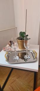 a tray with two wine glasses on a table at Ali app in Travnik