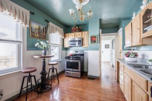 a kitchen with green walls and wooden floors and a counter at Room B1-Shared bathroom King Bed Washer Dryer in Rochester