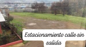 a view from a window of a dirt road at Hospedaje Alondra in Osorno