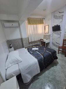 a bedroom with a large bed and a desk at Hotel Alloggio Del Conte in Naples