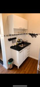 a kitchen with a sink and a counter top at Edifício Marília in Marília