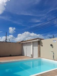 a swimming pool in the backyard of a house at Casa Vilarejo in Arembepe