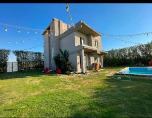 a house and a yard with a swimming pool at فيلا رامي رزق Luxury villa with private pool& complete privacy in 6th Of October
