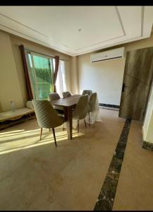 a dining room with a table and chairs at فيلا رامي رزق Luxury villa with private pool& complete privacy in 6th Of October