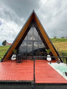 a building with a large window on a deck at Cabaña Nivura in Palmira +56 photos