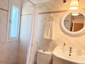 a bathroom with a toilet and a sink and a mirror at Studio 28 in Chios
