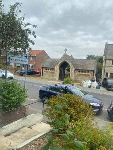 a car parked in front of a stone church at The Nest Chelmsford in Chelmsford