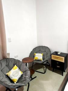 two chairs and a table in a room at Monstera Forest Lodge in Fortuna +62 photos