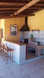 a kitchen with a counter and a fireplace at Life Pinhalzinho in Pinhalzinho