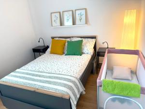 a small bedroom with a bed with colorful pillows at Apartament Żabie Oczko in Zator
