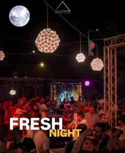 a crowd of people sitting in a room with lights at Disco tour Open Air Djerba in Djerba