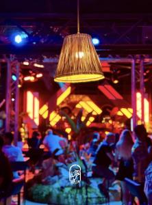 a group of people sitting at a restaurant with a light at Disco tour Open Air Djerba in Djerba