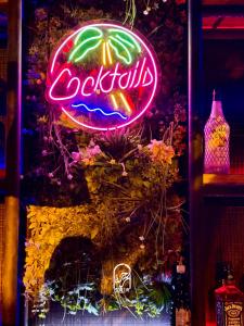 a neon cocacola sign hanging on a wall at Disco tour Open Air Djerba in Djerba