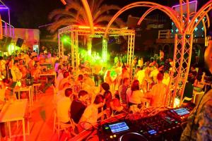 a group of people sitting in a crowd at a party at Disco tour Open Air Djerba in Djerba