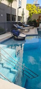 a swimming pool with a boat in the water at Apê Brisa-5min consulado EUA-garagem in Porto Alegre