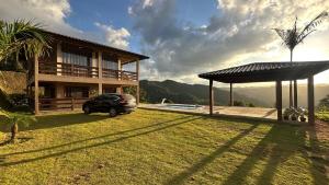 a car parked in a yard next to a house at Recanto HipoMar in Marechal Floriano