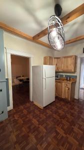 a kitchen with a white refrigerator and a table at Cozy Oneonta Getaway in Oneonta +9 photos