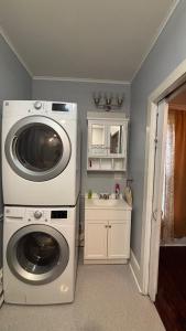 a laundry room with a washing machine and a sink at Cozy Oneonta Getaway in Oneonta