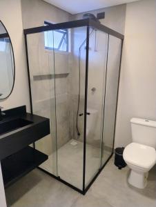 a glass shower in a bathroom with a toilet at Villa Parati Bombinhas Sob Nova Direção in Bombinhas +41 photos