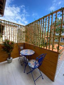 a patio with two chairs and a table on a balcony at Gaglian's Suites Lake Como in Como