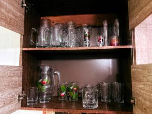a bunch of glass jars sitting on a shelf at Escápate a Jacó apartamento completo in Jacó +8 photos