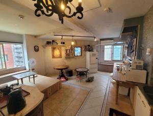 a kitchen and living room with a chandelier at The hostel kobe in Kobe