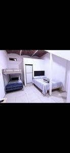 two pictures of a bedroom with two beds at Adonai in Rincon de Guayabitos +12 photos
