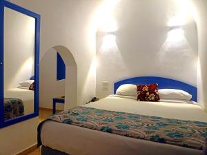 a bedroom with a bed with two lights on the wall at kanabesh hotel in Sharm El Sheikh +36 photos