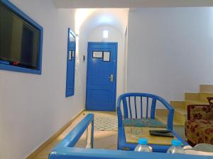 a room with a blue door and a blue chair at kanabesh hotel in Sharm El Sheikh