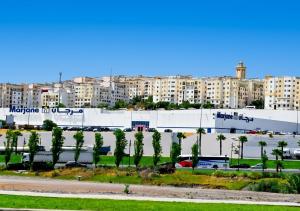 a city with a building and palm trees and buildings at Morjan apart in Tangier