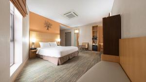 a hotel room with a bed and a desk at Central Seven Hotel by Kwon Busan Seomyeon in Busan
